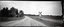 Placeholder: old wester railroad crossing a dirt road , grayscale, antique photo