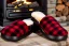 Placeholder: Red plaid slippers on black bearskin rug,log cabin walls, stone fireplace