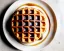 Placeholder: Round waffle with maple syrup plate, fork