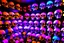 Placeholder: hundreds of non-anatomically correct, dark comic art, graphic novel,human skulls stacked into a wall unusual neon lighting, high velocity, 64k, dystopian, vray, a picture of a dark, comedic, anatomically correct wall of colorful tightly packed skulls of varying sizes and expressions, photo realistic, insanely meticulous, highly detailed, part of a collection of bones on display, 64k, dystopian, vray , ALL DRAWN IN THIN LINES OF NEON LIGHT AND COLORS