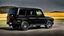Placeholder: A sleek (((BMW G Wagon))) with a majesticly curved rear, cutting through a (sunny, open countryside) backdrop
