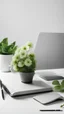 Placeholder: workplace, grey PC notebook with team call, glass cup club of tea, backgroud white wall and green flower