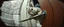 Placeholder: weird ass squirrel burglar breaking open a door with a crow bar , pinhole cam, airbrush 3d rendering, in the style of John Atkinson Grimshaw , torn edges on border