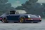 Placeholder: a dark Porsche carrera 964, wide-body, pandem, rocket bunny, carbon fibre, drift car, jdm wheels and rims, ultra realistic,concept art,in tokyo