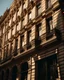Placeholder: facade of huge building in a Spanish city, close-up, real photography, photojournalism, 16K, shot with Leica camera, 35 mm lens, warm light between shadows