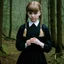 Placeholder: Young dakota fanning as Wednesday addams, braids, bangs, in tge woods