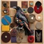 Placeholder: Collage of various mediums making up an abstract crow image, metal and glass and fabric and corduroy and wood and paper and velvet and yarn, various rough textures, sharp contrast, pronounced textures, sharp juxtaposition of materials, colorful, sharp focus, maximalism, by Jean Tinguely