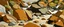 Placeholder: A brown shoreline with rocks painted by Stuart Davis