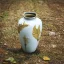 Placeholder: photo of a small cracked ceramic vase repaired with gold, kintsugi, garden setting, beautiful landscape photography, beautiful, vines and leaves, delicate, cinematic, high detail, beautiful composition, delicate arrangement, aesthetic, soft lighting, award winning photography, tender