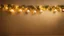 Placeholder: Little Christmas Decorations With Garland Lights On Golden Textured Wall.