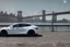 Placeholder: A Tesla 'Model Y' is drifting at high speeds, near the 'Pier 11' in Manhattan. (CINEMATIC, WIDE ANGLE LENS, PHOTO REAL)