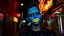 Placeholder: A person with a blue painted face and bright yellow lemon-shaped lips, standing in a dark alleyway at night, illuminated by neon signs, wearing a black leather jacket.
