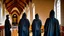 Placeholder: black robe hooded monks in the chapel