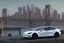 Placeholder: A Tesla 'Model Y' is parked, near the 'Pier 11' in Manhattan. (CINEMATIC, WIDE ANGLE LENS, PHOTO REAL)