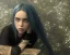 Placeholder: Billie Eilish, sitting on a chair, Black Short Dress, high detail, realistic, 8k