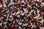 Placeholder: [dices and skills] close-up high res photo by Barry Webb: a gypsy's wrist surrounded and saturated by strings of pearls, the hundreds of pearls in every color shaped like dice or skulls. It's the childlike, mortal symbol of chance intertwined with destiny.