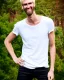 Placeholder: a tall guy who is skinny and scrawny with blond hair and blond beard. his hair is to the left side and he wears glasses. he is wearing a white t-shirt, black jeans and has straight teeth and brown shoes