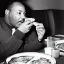 Placeholder: Martin Luther King Jr. eating pizza at a Denny's restaurant