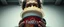 Placeholder: close up portrait of a ramen bucket that looks like a chain saw wielded by serious angry law man, in cinema