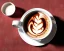 Placeholder: Cappuccino art microfoam in mug saucer plaid napkin