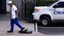 Placeholder: delivery man wears crocs shoes at the gate