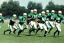 Placeholder: Boston Shamrocks Football team playing against the Toronto Rifles Football team, vintage, hyper-realistic, in color, 1950s football