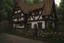 Placeholder: large medieval gothic, wooden inn, with a balcony, next to a cobbled road, in a wood, dense foliage, photo-realistic