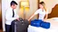 Placeholder: hotel employee rummaging through customer's suitcase