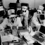 Placeholder: scientists at the computer in carnival masks. the masks are checkered.