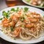 Placeholder: Closeup of a shrimp Pad Thai,rice noodle Selective focus; shallow depth of field on a restaurant kitchen table