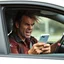 Placeholder: A very angry and bitter punk rocker sitting in a car driving angry, looking at oppsite drivers with looking at their phones