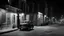 Placeholder: 1950s Chicago, street, night exterior, a car parked in front of an alley, captured on a 35mm camera, black and white, classic film. Car interior, night.