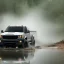 Placeholder: hyperrealistic shot, fast moving 4x4 truck, monotone color palette, sharp focus, puddle reflec1tion, tire mud splashes, refraction, mist on the horizon, thunder and lightning, overcast shadow, detailed and intricate, cinematic composition, 8k, micro, tilt shift photography, bokeh