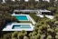 Placeholder: Day in quinta do lago, one straight line building of two floors on a slope of pine trees, with a 250 meters long pool on the rooftop building, modernistic luxury villa architecture with wood and gold metallic pergolas with pool on rooftop, on a slope with pinus pinea, metallic wood and black pergolas