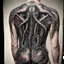 Placeholder: Bad tattoo, back xenomorph hitchhiker tattoo in style of H.R. Giger reading "NO REGERTS", text, photorealistic, by Joel-Peter Witkin