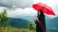 Placeholder: Hyper Realistic Photographic View Of Beautiful Young Happy Pashto Woman With Beautiful-Black-Mascara-Eyes-&-Black-Hair Wearing Black-Frock & Black-Shawl-With-Maroon Embroidery Happily Carrying An Red Umbrella On Mountain-Top With Greenery & Breathtaking Cloudy-Rainy-Weather Showing Dramatic & Cinematic Ambiance.