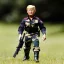 Placeholder: G.i. Joe toy camouflage doll sunburn Donald Trump face with boots full body in package high resolution 2019, in a box with gun