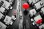 Placeholder: top-down view of a clean black and white wet city street with houses, one pedestrian with a red umbrella, surreal style