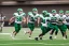 Placeholder: Boston Shamrocks Football team playing against the Toronto Rifles Football team,vintage, hyper-realistic, in color, Boston in green, Toronto in Red