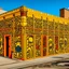 Placeholder: A yellowish orange colored electrical facility designed in African pottery painted by Keith Haring