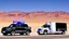 Placeholder: A police Tesla Cybertruck is chasing a Tesla 'Model S Plaid' at top speed, at the 'Lake Mead', in Nevada. CINEMATIC. WIDE ANGLE LENS.