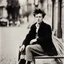 Placeholder: Color picture sitting on a bench in Paris: Biographie, photographie et citations de Arthur Rimbaud. Jean Nicolas Arthur Rimbaud est un poète français (with a messy hairdo,)