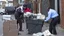 Placeholder: woman hands the bundles of cash her mobile phone provider's located across the street from a high crime area