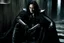 Placeholder: Action shot of Tom Hiddleston as Alucard from the live action "Hellsing" movie based on the anime of the same name. He is sitting, arms chained to a dungeon wall. He appears to be corpse wearing black wrappings that cover all except his head, feet, and hands. His straight, black hair hangs to the floor. A vague smile is on his gaunt face.