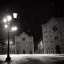 Placeholder: A very dark square in Florence in a stormy night. Snow is covering the pavement. A cathedral in the background. A lonely cat sitting under a streetlight. Unreal Engine. HDR. 8K.