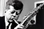 Placeholder: Lonely John f kennedy playing A normal saxophone with his eyes closed