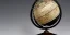 Placeholder: fantasy world globe, black marble, pearl inlay, fine gold detail, marginalia