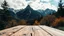 Placeholder: low angle of a wooden table in the foreground and a mountain view in the background