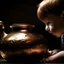 Placeholder: The reflection of a child on the surface of an old copper teapot