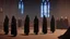 Placeholder: black robe hooded monks in the chapel